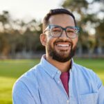 Portrait of happy mid adult man smiling at sunset